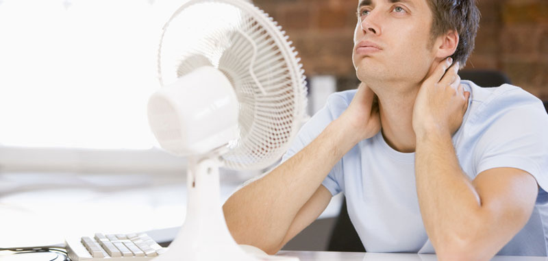 man not satisfied with cooling temperature provided by fan alone