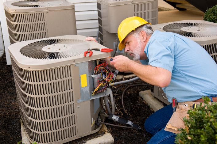 experienced technician performs HVAC maintenance