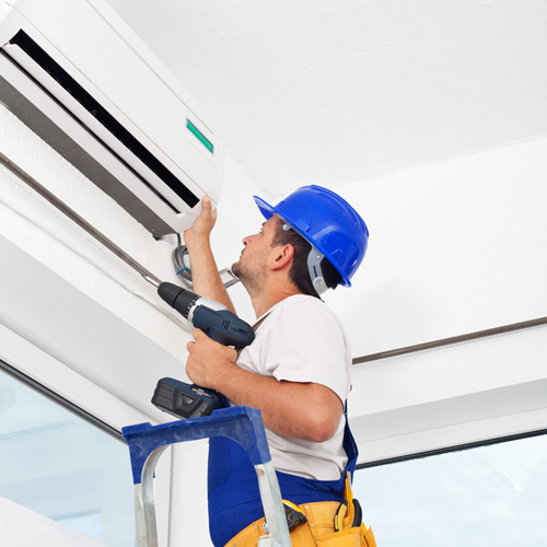 technician repairing air conditioning system